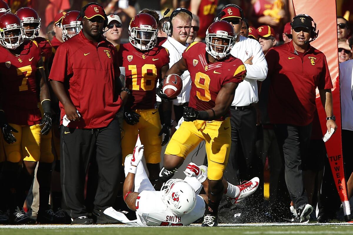 Trojans receiver Juju Smith gets past Bulldogs safety Derron Smith for a big gain in the first quarter.