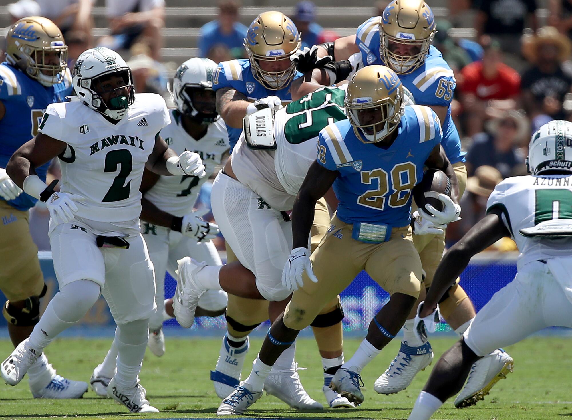 UCLA running back Brittain Brown looks for room to run against Hawaii in the second quarter.