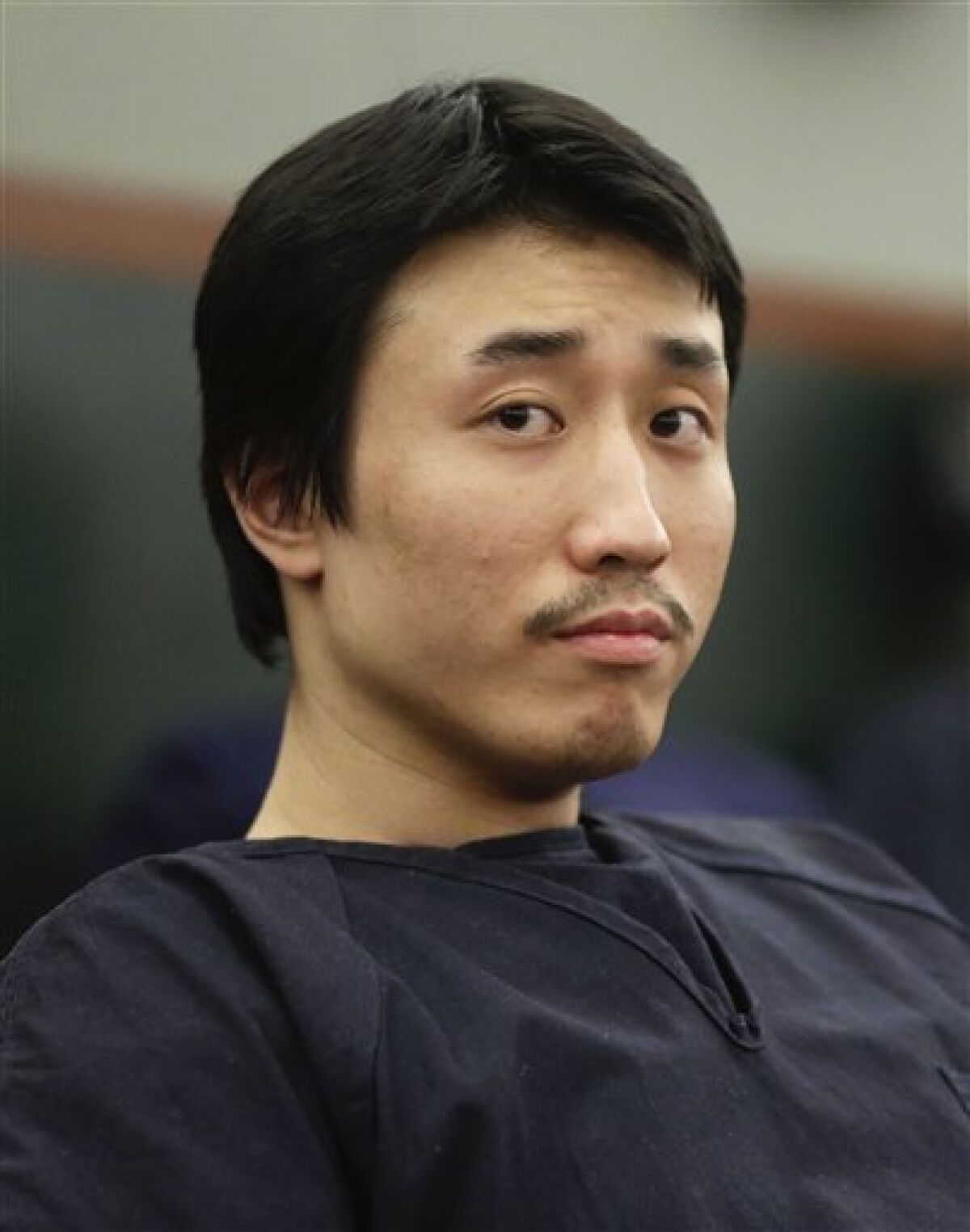 Xiao Ye Bai awaits his sentencing, Tuesday, March 5, 2013, in Las Vegas. The 26-year-old Chinese immigrant, convicted of being an enforcer for a Taiwan-based criminal gang, will spend the rest of his life in a Nevada prison for killing one person and wounding two others in a bloody knife attack in a Las Vegas karaoke bar in July 2009. (AP Photo/Julie Jacobson)