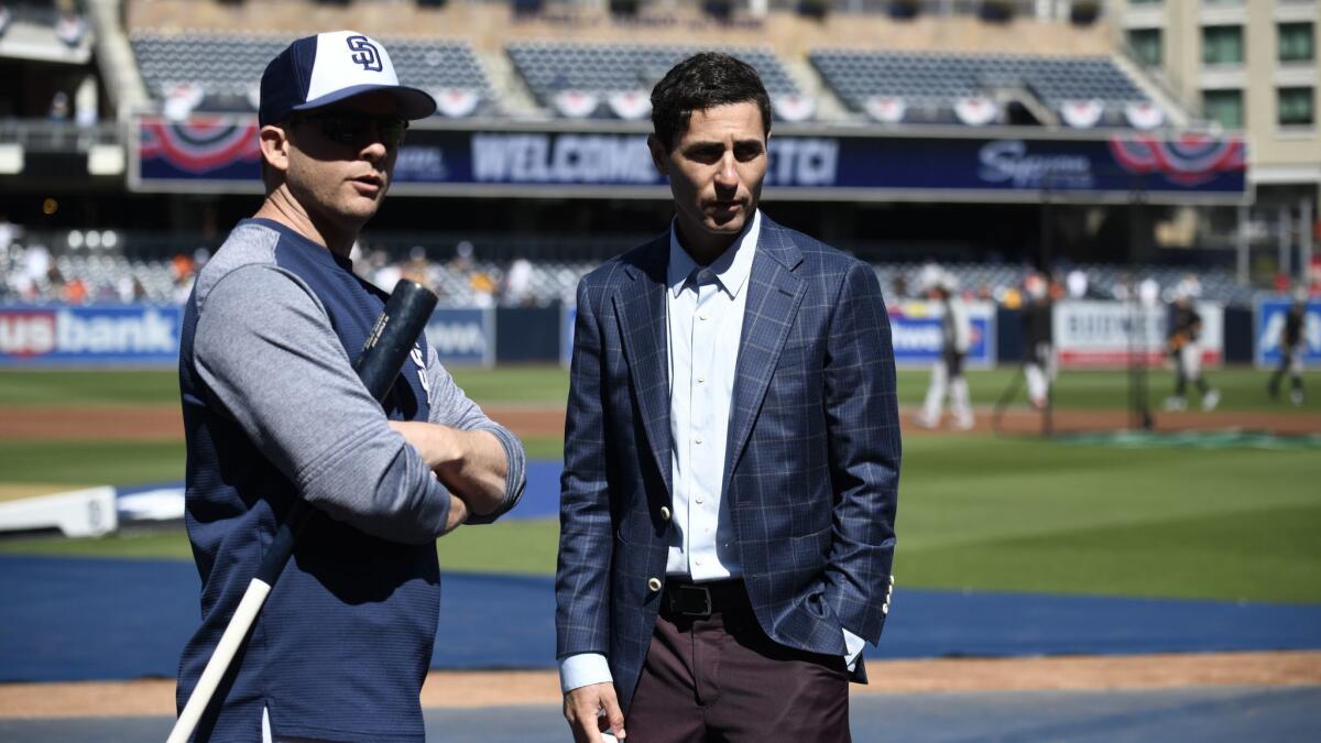 San Diego Padres manager Andy Green, left, talks to Padres general manager A.J. Preller before the team's season opener against the San Francisco Giants.