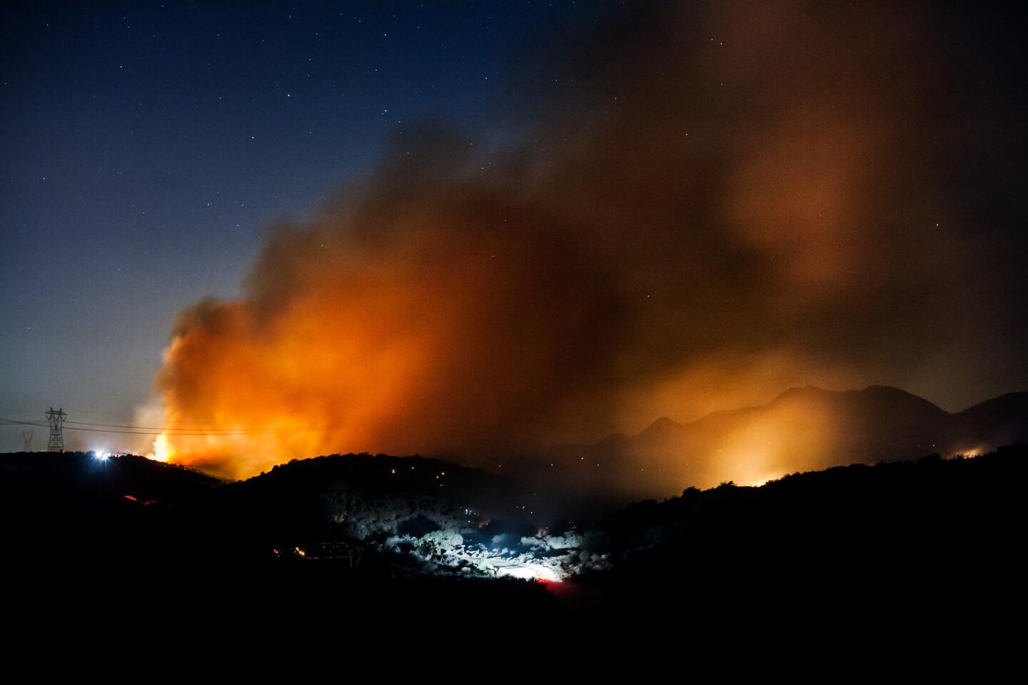 A brush fire burns near Baldy Mesa in the San Bernardino Mountains on July 17, 2015, after the blaze jumped Interstate 15 in California.