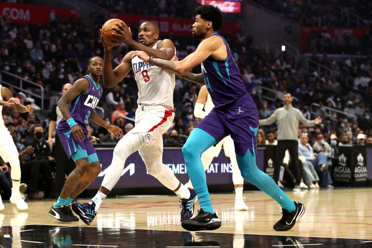 Clippers forward Serge Ibaka drives to the basket against Charlotte's Nick Richards during the first quarter Sunday.