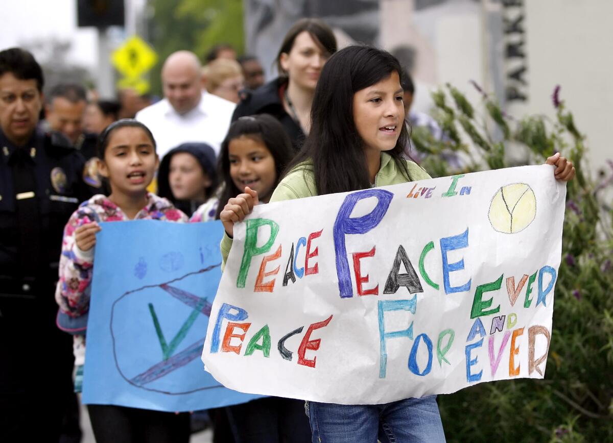 Children and adults marched from Villa Parke Community Center to Jackie Robinson Park during Cesar Chavez Peace Rally in Pasadena on Saturday, March 31, 2012. The rally also honored slain Florida teen Trayvon Martin, who was shot dead by George Zimmerman in Sanford, Fla. in February 2012.
