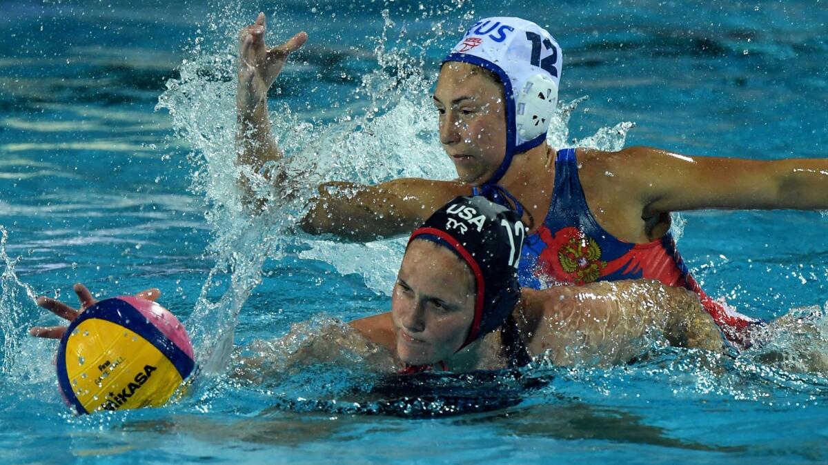 Former Edison star Alys Williams, bottom, fights for the ball with Daria Ryzhkova of Russia during Wednesday's semifinal match of the FINA World Championships in Budapest.