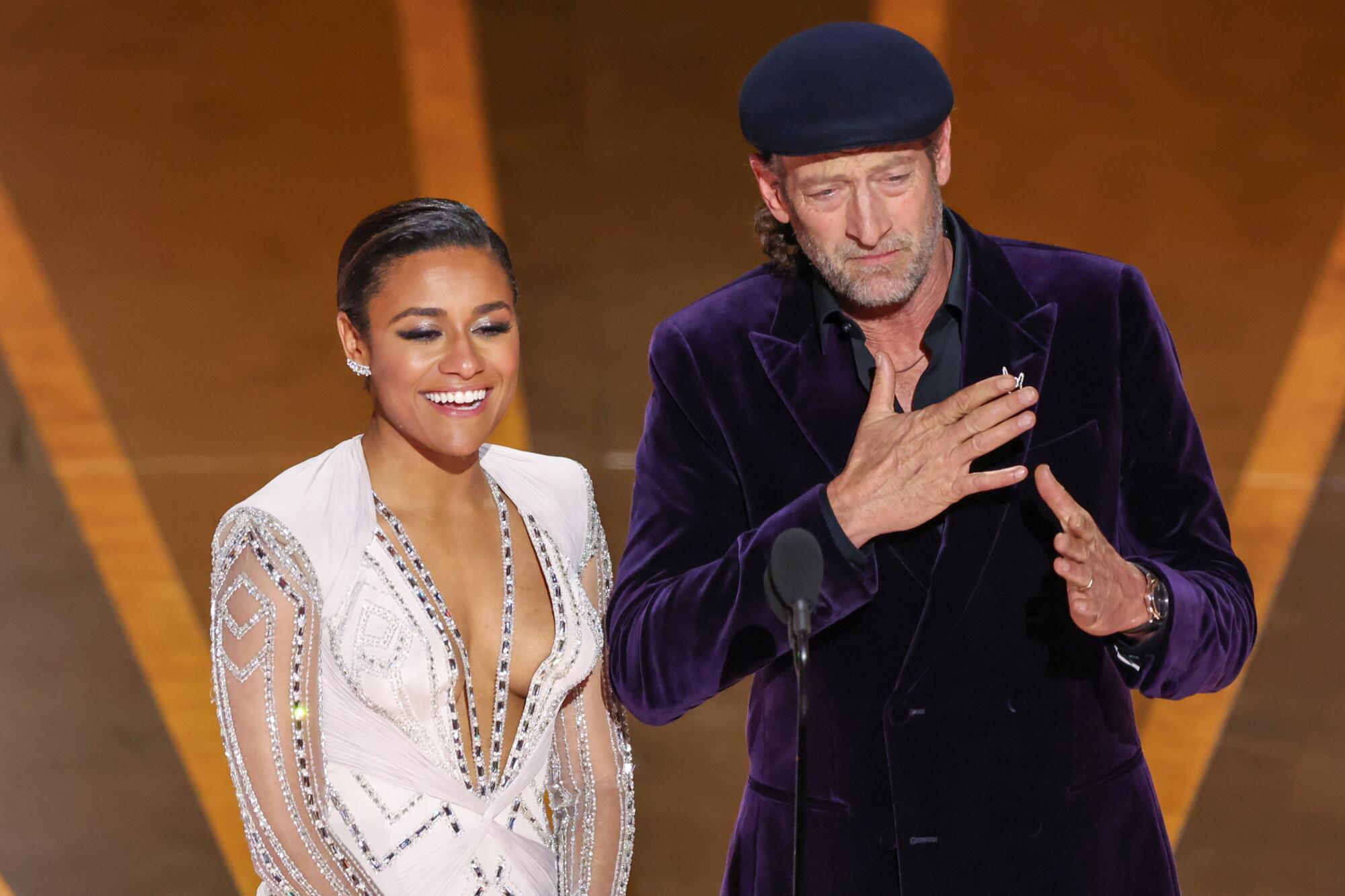 Two actors onstage at the Academy Awards