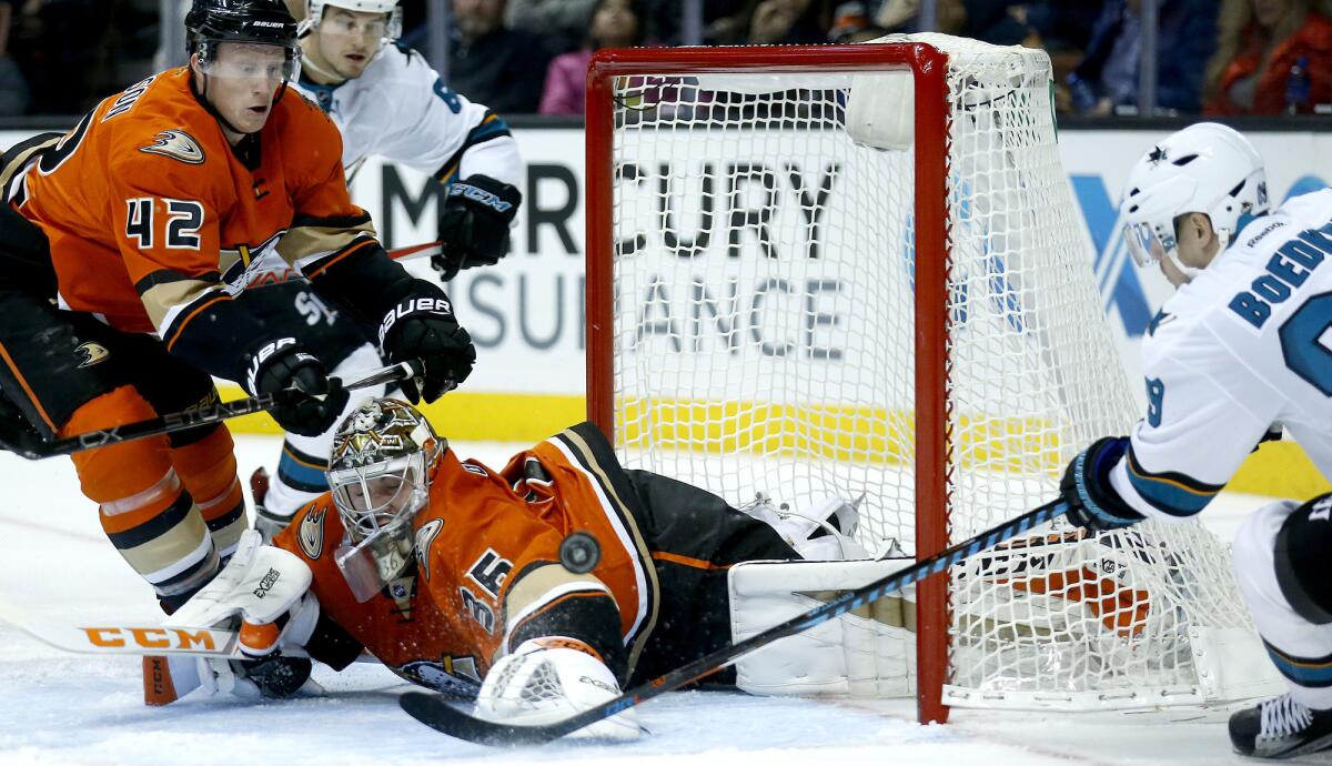 Ducks goalie John Gibson (36) stops a shot by Sharks left wing Mikkel Boedker during the second period Tuesday night at Honda Center.