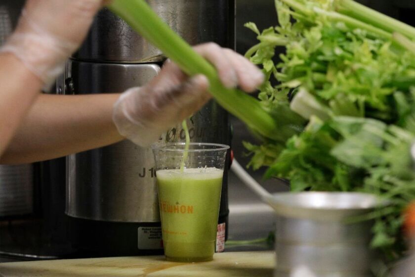 LOS ANGELES, CA -- MAY 14, 2019: Celery juice being made at the Tonic Bar inside Erewhon Market in Los Angeles. It takes about 12 average-sized stalks to make a 20-ounce drink. (Myung J. Chun / Los Angeles Times)