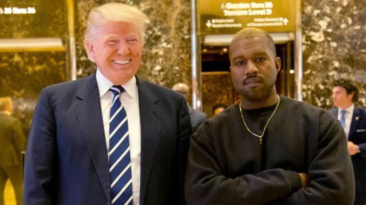 President-elect Donald Trump and Kanye West pose for a picture in the Trump Tower lobby on Dec. 13, 2016.