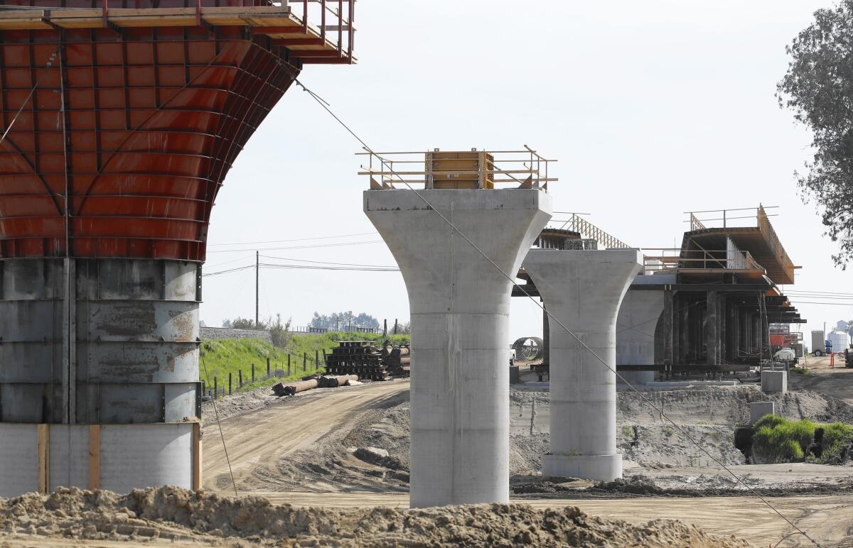 Supports for a 1,600-foot viaduct to carry high-speed trains across the Fresno River are under construction near Madera.