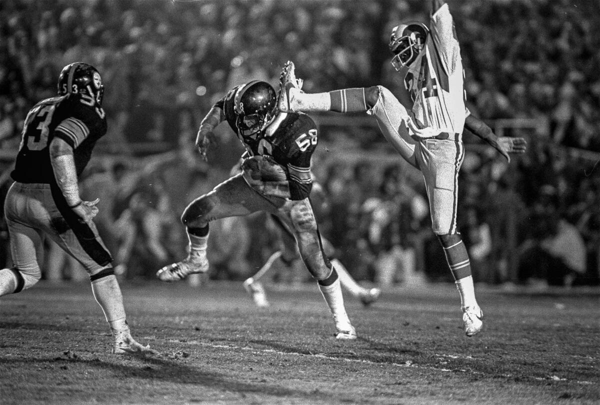 Jan. 20, 1980: Steelers linebacker Jack Lambert (58) comes down with the ball after intercepting a pass meant for Rams receiver Ron Smith (84) in the fourth quarter of Super Bowl XIV.