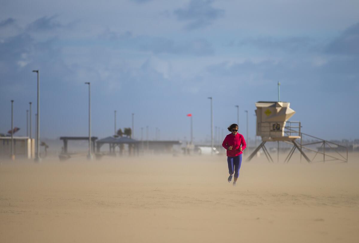 Ciara Reistad runs along Bolsa Chica State Beach Monday, Jan. 25. 