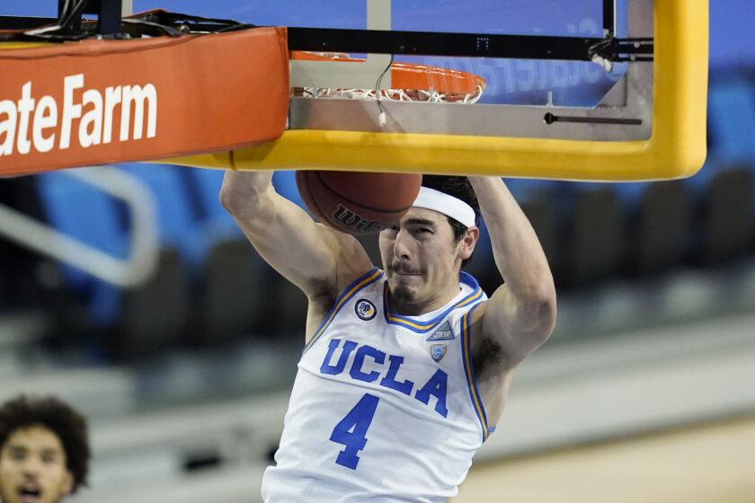UCLA guard Jaime Jaquez Jr. (4) dunks the ball during the second half of an NCAA college basketball game against the Washington Saturday, Jan. 16, 2021, in Los Angeles. (AP Photo/Ashley Landis)