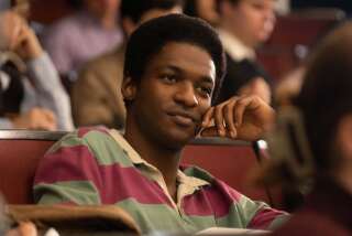 A Black student sits in a college class.