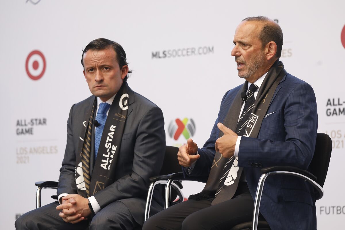 MLS commissioner Don Garber, right, and Liga MX president Mikel Arriola, left, talk with media