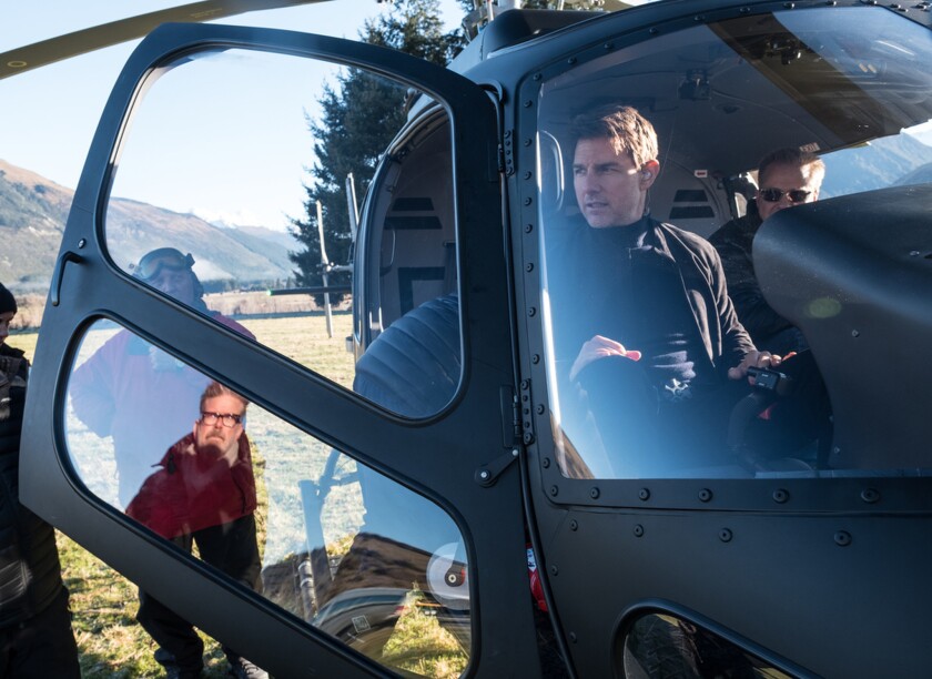 Director Christopher McQuarrie, in window reflection, and Tom Cruise on the set of 