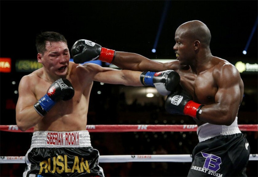 Timothy Bradley, right, punches Ruslan Provodnikov in the fourth round of their WBO welterweight title match.