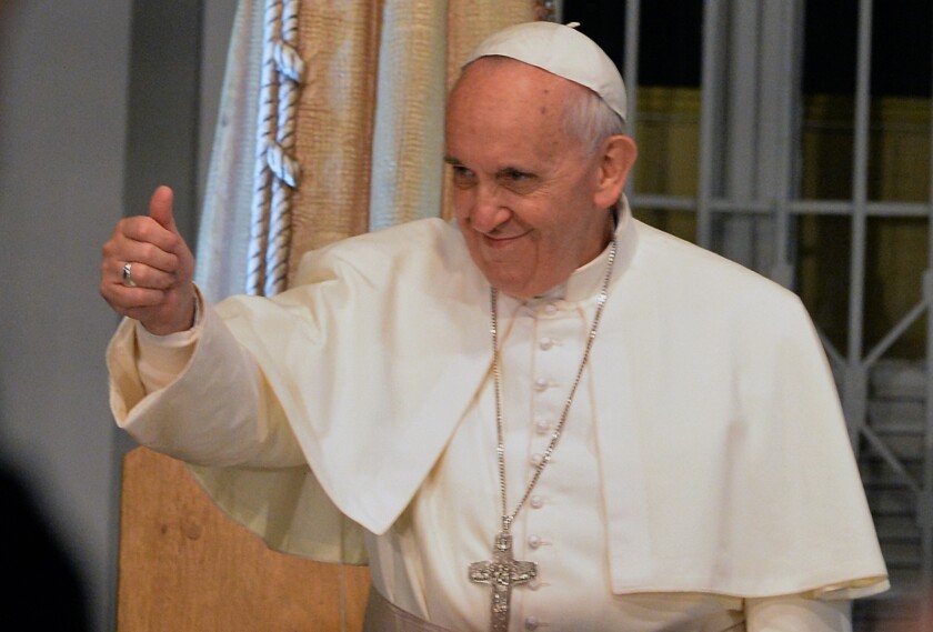 Pope Francis gives a thumbs-up during his visit to a hospital in Rio de Janeiro in 2013.