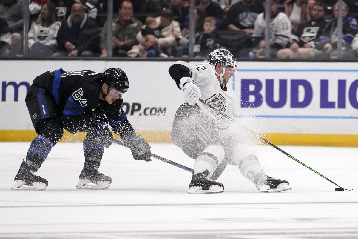 The Kings' Kevin Fiala, right, and the Maple Leafs' David Kampf battle for the puck Oct. 29, 2022.