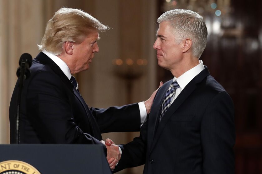 President Trump announces the Supreme Court nomination Tuesday of appeals court Judge Neil Gorsuch, right.
