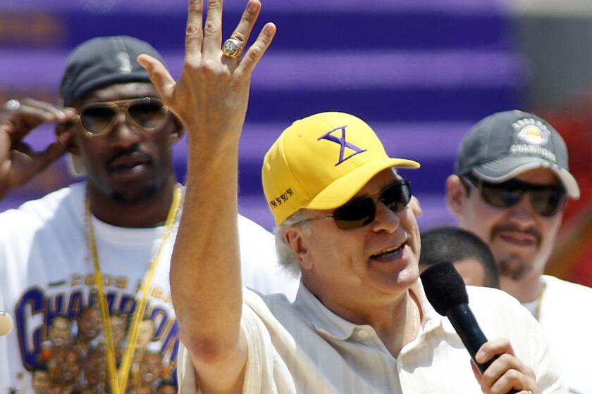 Former Lakers Coach Phil Jackson shows off one of his NBA championship rings during the Lakers championship celebration in 2009.