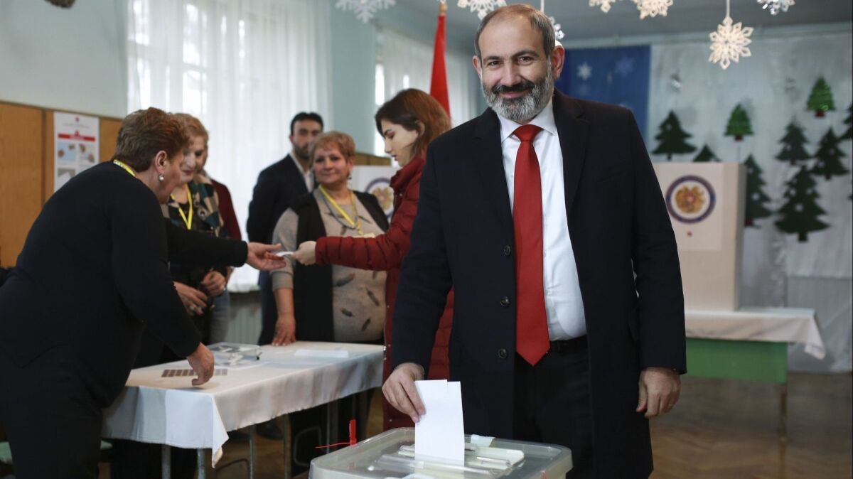 Armenian Prime Minister Nikol Pashinian casts his ballot during early parliamentary elections in Yerevan on Dec. 9.