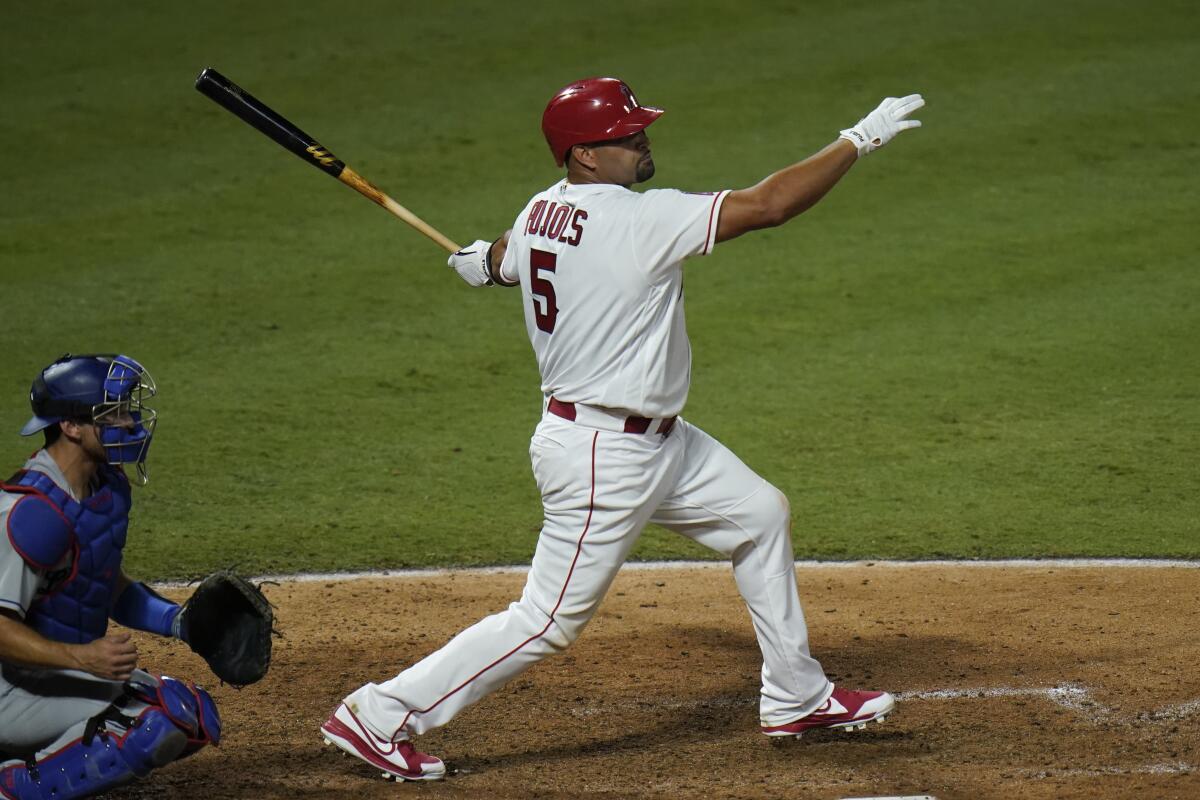 Angels' Albert Pujols hits a single against the Dodgers.