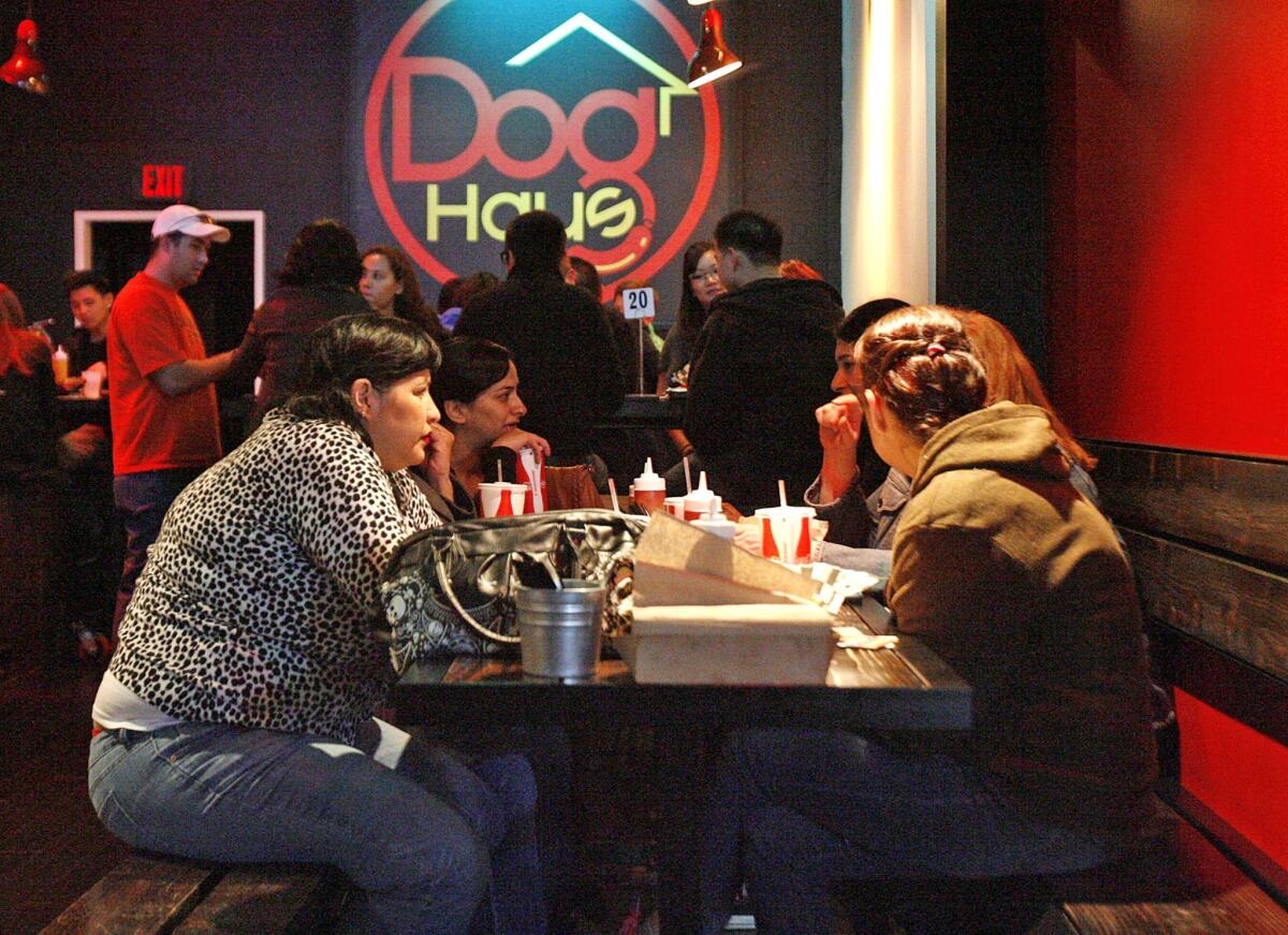 Restaurant patrons are shown at the Dog Haus in Pasadena. The company is opening four new franchise locations this fall, in Burbank, West Covina, Thousand Oaks and Santa Ana.