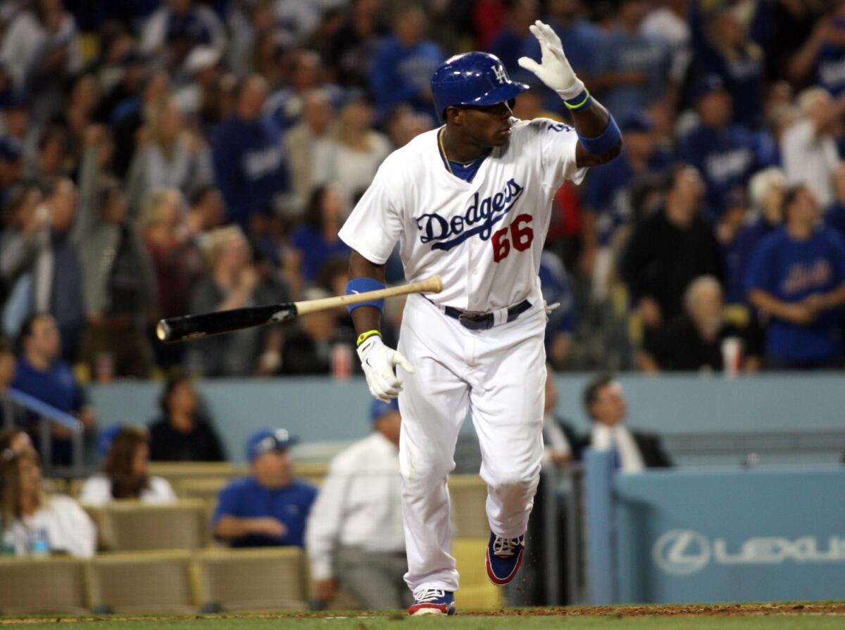 Dodgers right fielder Yasiel Puig tosses his bat after driving in the go-ahead run on a sacrifice fly in the sixth inning of the Dodgers' 4-2 win over the New York Mets on Monday.
