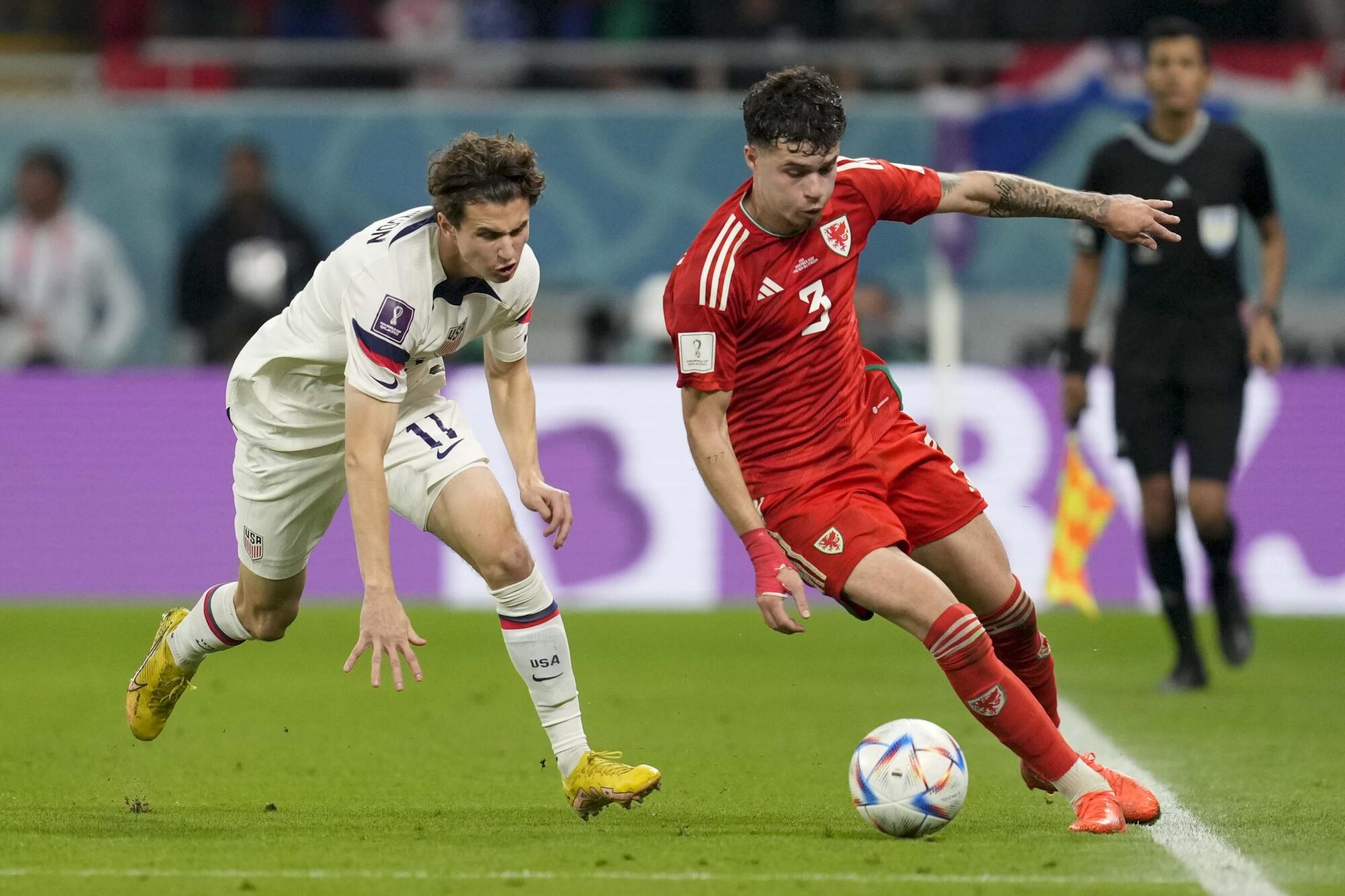 Wales defender Neco Williams, right, controls the ball in front of U.S. midfielder Brenden Aaronson.