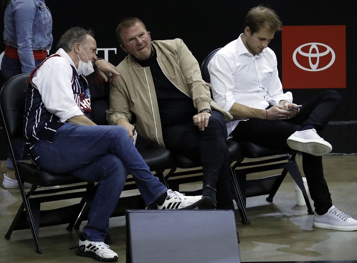 Houston Rockets owner Tilman Fertitta, center, team president Tad Brown, left and Patrick Fertitta sit courtside as the Rockets played the Los Angeles Clippers in an NBA basketball game Friday, May 14, 2021, in Houston. (Bob Levey/Pool Photo via AP)
