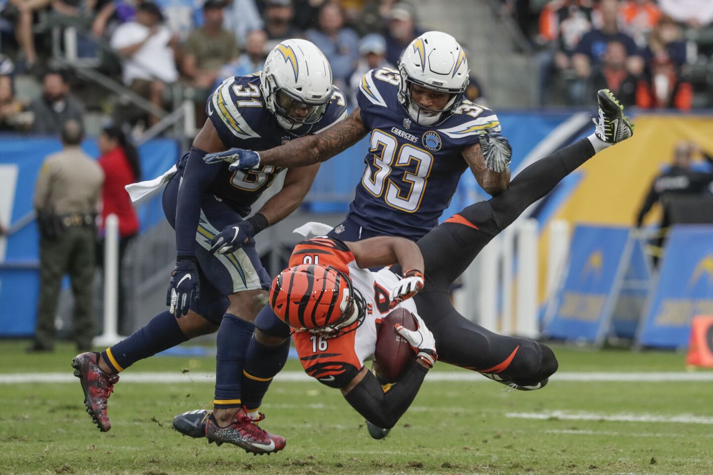 Chargers safety Derwin James upends Bengals receiver Cody Core during the third quarter drive.
