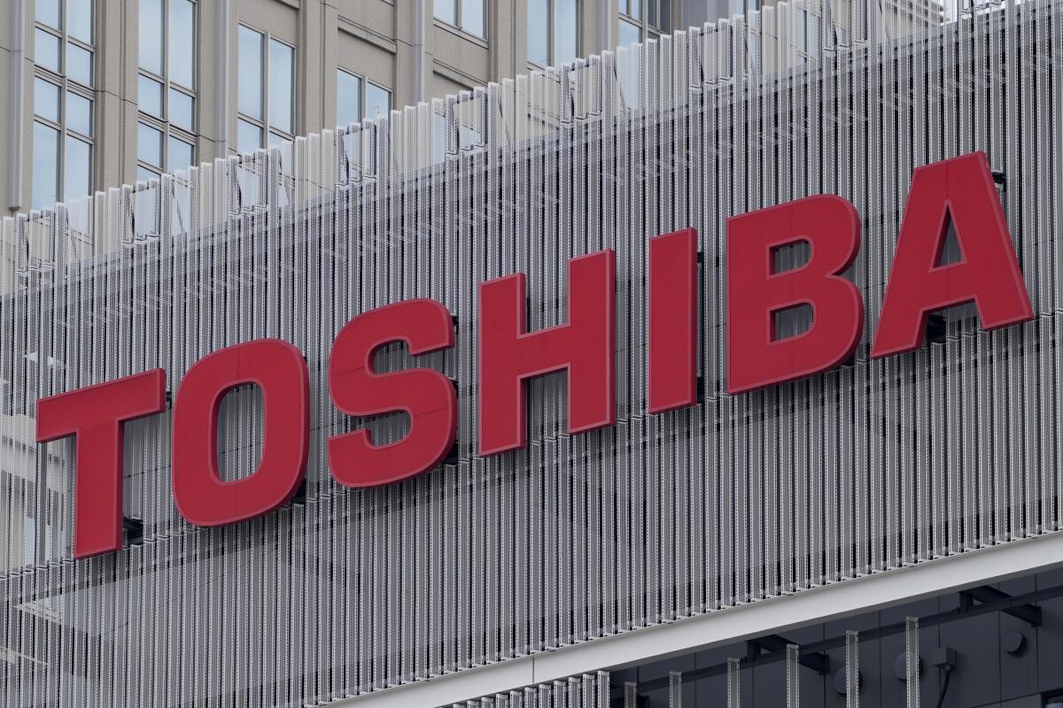 FILE - The logo of Toshiba Corp. is seen at a company's building in Kawasaki near Tokyo, on Feb. 19, 2022. Toshiba reported Wednesday, Aug. 8, 2022, a 44% improvement in profit for the first fiscal quarter as the Japanese technology giant sought to revamp its brand image and reassure investors about its management. (AP Photo/Shuji Kajiyama, File)