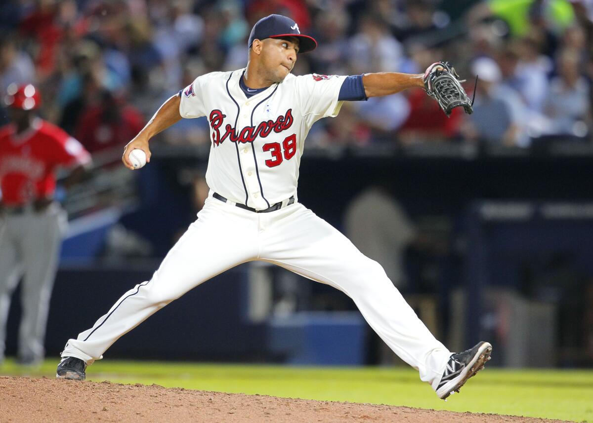 FILE - Atlanta Braves relief pitcher Anthony Varvaro delivers in the sixth inning of a baseball game against the Los Angeles Angels on June 15, 2014, in Atlanta. Varvaro, a former MLB pitcher who retired in 2016 to become a police officer in the New York City area, was killed in a car accident Sunday, Sept. 11, 2022, on his way to work at the Sept. 11 memorial ceremony in Manhattan, according to police officials and his former teams. (AP Photo/Todd Kirkland, File)
