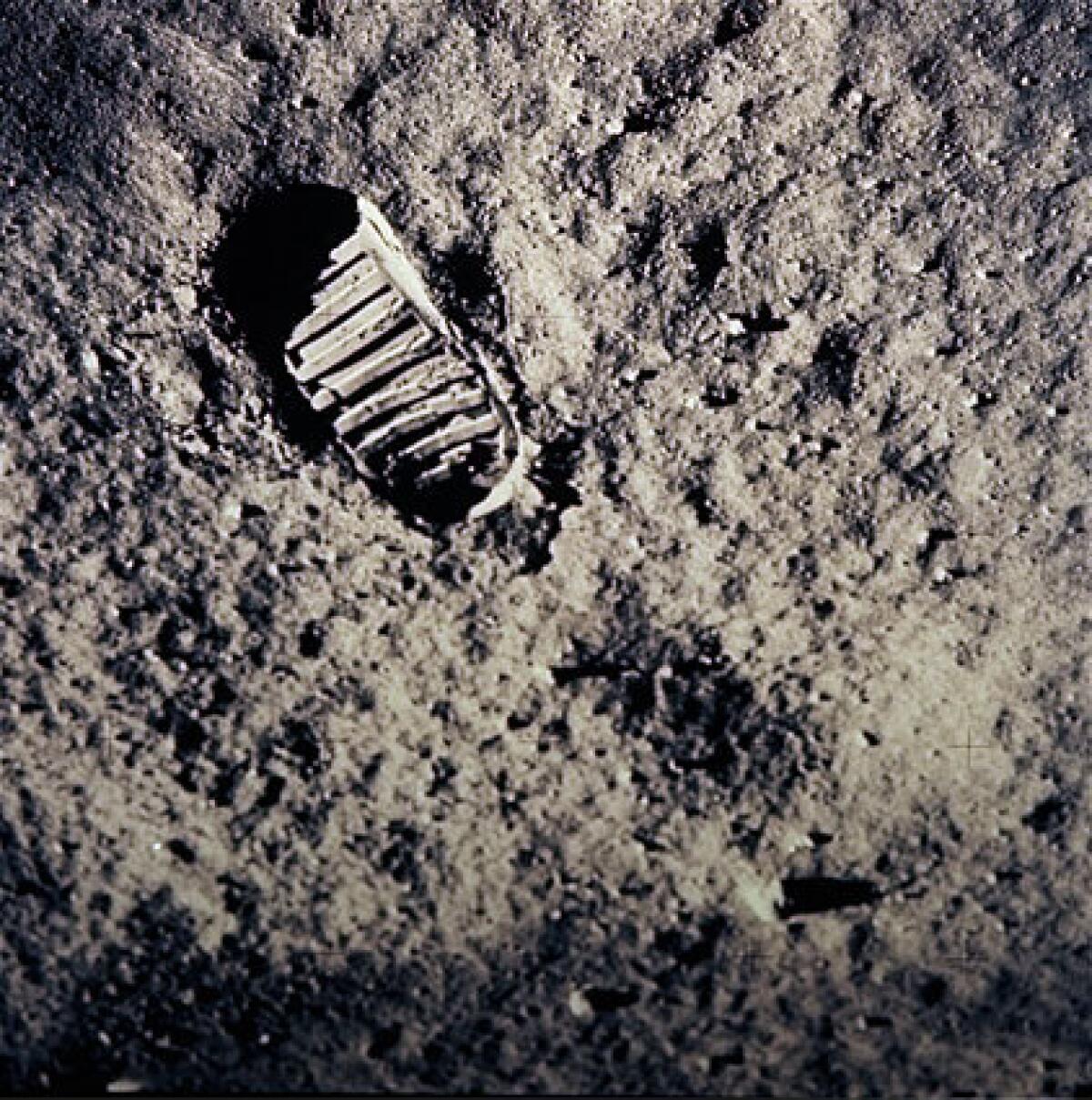 A boot print marks the lunar surface. The next time NASA sends astronauts to the moon, one will be a woman.