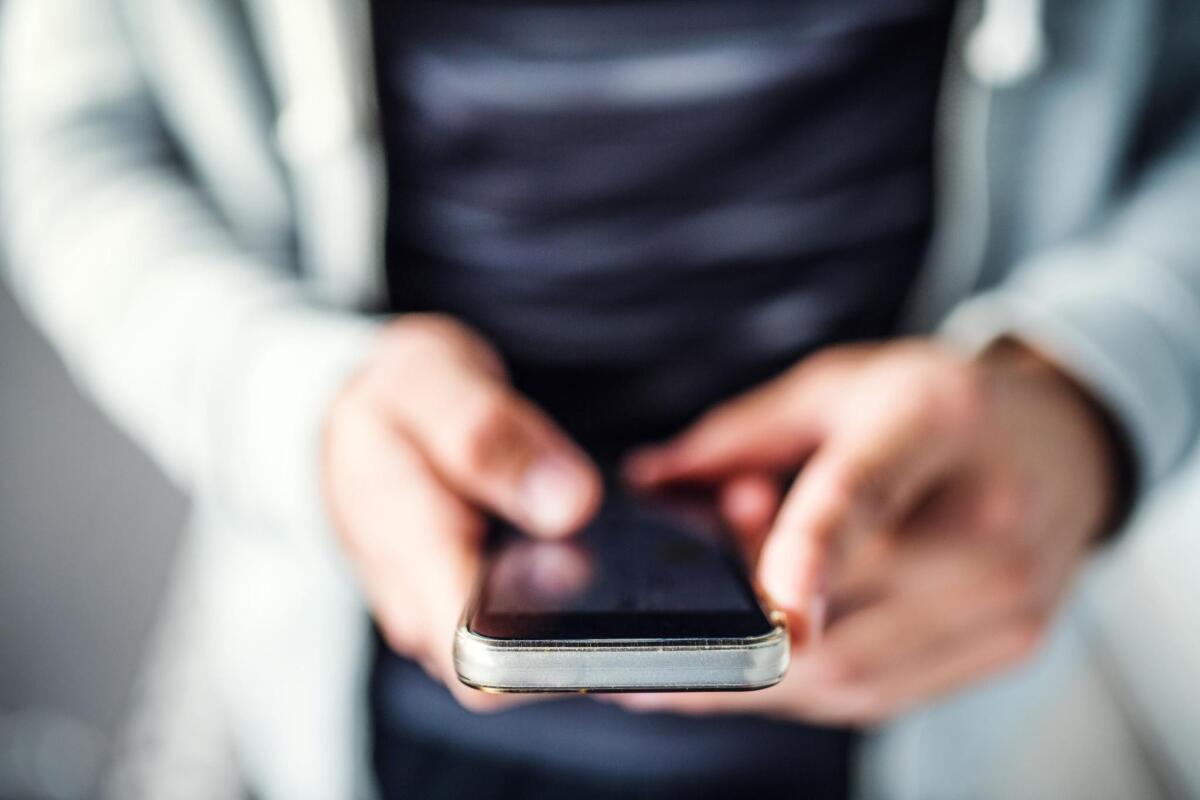 Hands holding a smartphone.