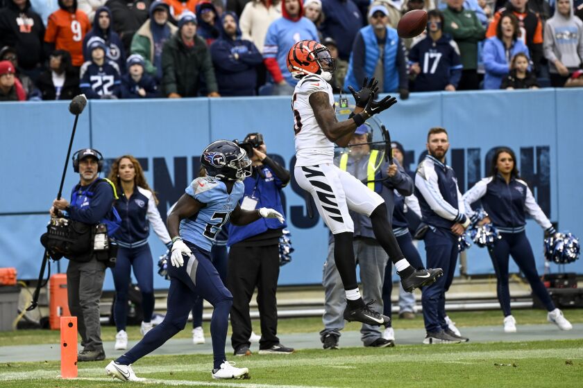 Cincinnati Bengals wide receiver Tee Higgins (85) makes a touchdown catch against Tennessee Titans cornerback Roger McCreary (21) during the second half of an NFL football game, Sunday, Nov. 27, 2022, in Nashville, Tenn. (AP Photo/Mark Zaleski)