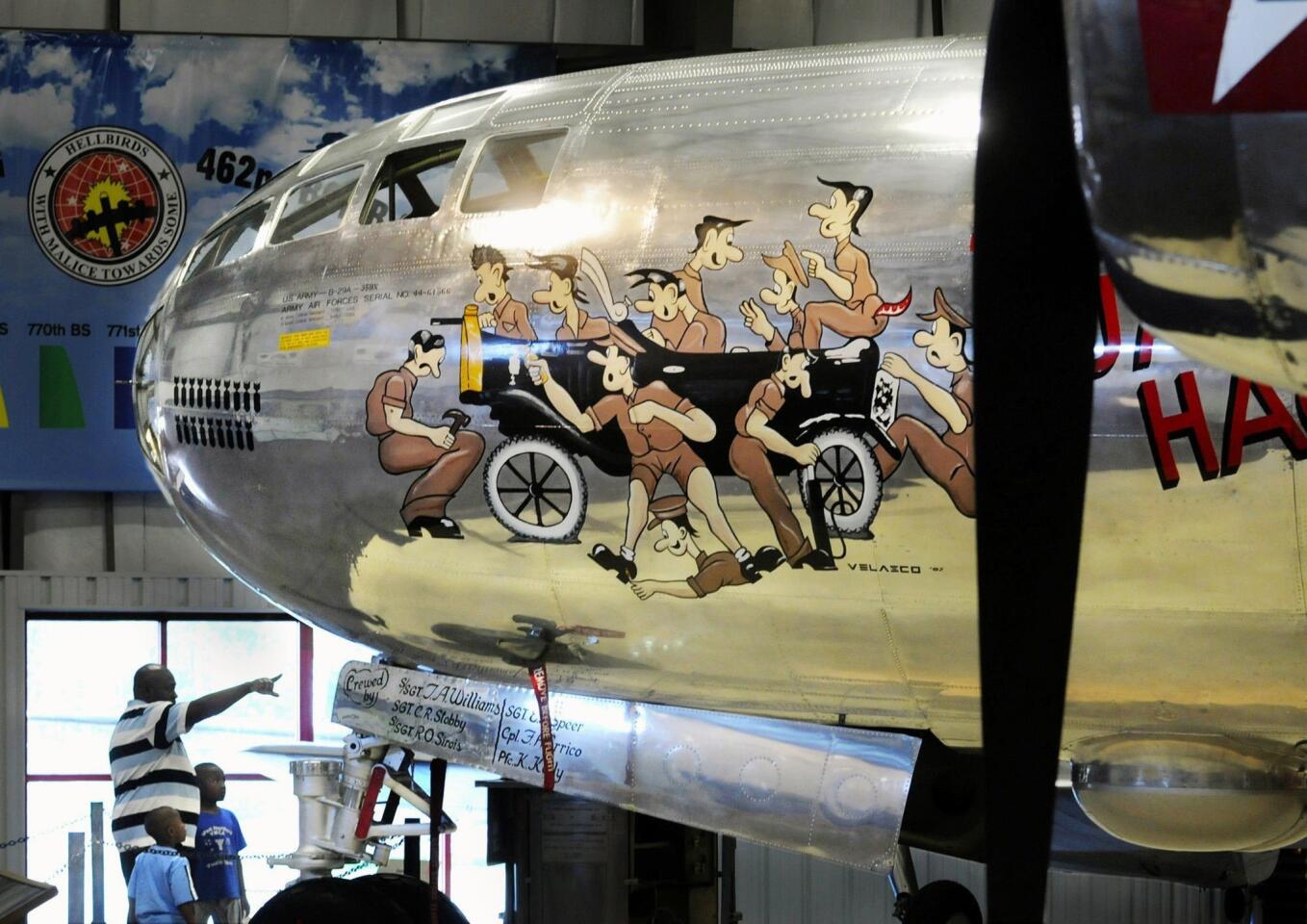 WINDSOR LOCKS 4/20/10- The 1945 Boeing B-29A Superfortress occupies it's own hangar, the 58th Bomb Wing Memorial, at the New England Air Museum. Aquired in pieces in 1973, the big bomber was later extensively damaged during the 1979 tornado that hit the area of the old air museum. For the next 20 years, the old hulk of a plane sat in an outdoor display area and became home to many birds and animals. In 1999, the restoration began, using the fuselage of three planes. The restoration is nearly complete and the shiny B-29A sits proudly inside the pristine hangar. In photo, Brian Williams of Windsor shows the plane to his sons, Kisimi, 4, and Kwane, 7, during a school vacation trip to the museum. STEPHEN DUNN|sdunn@courant.com ORG XMIT: 10014546A