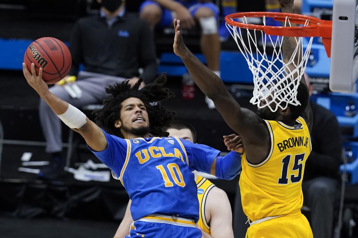 UCLA guard Tyger Campbell shoots over Michigan guard Chaundee Brown during the Bruins' Elite Eight win Tuesday.