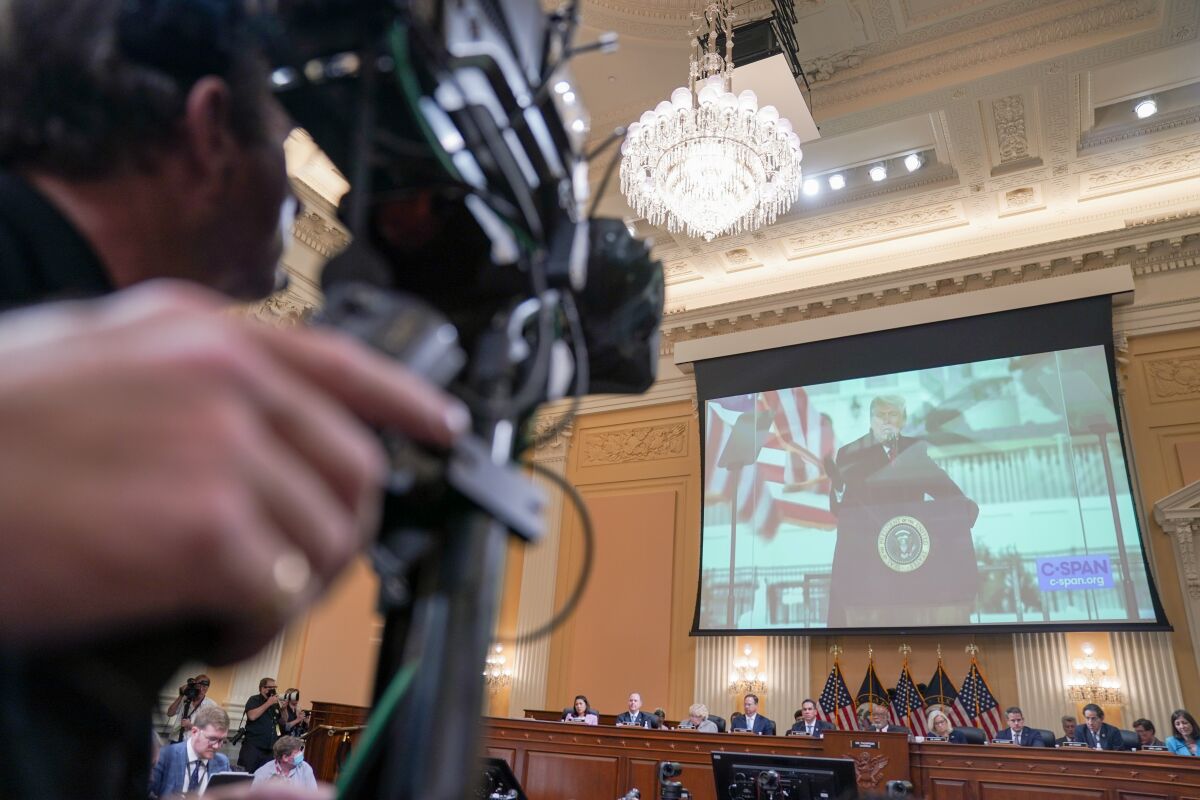 Photos of then-President Trump are shown during a House Select Committee to Investigate the January 6th hearing on Thursday.