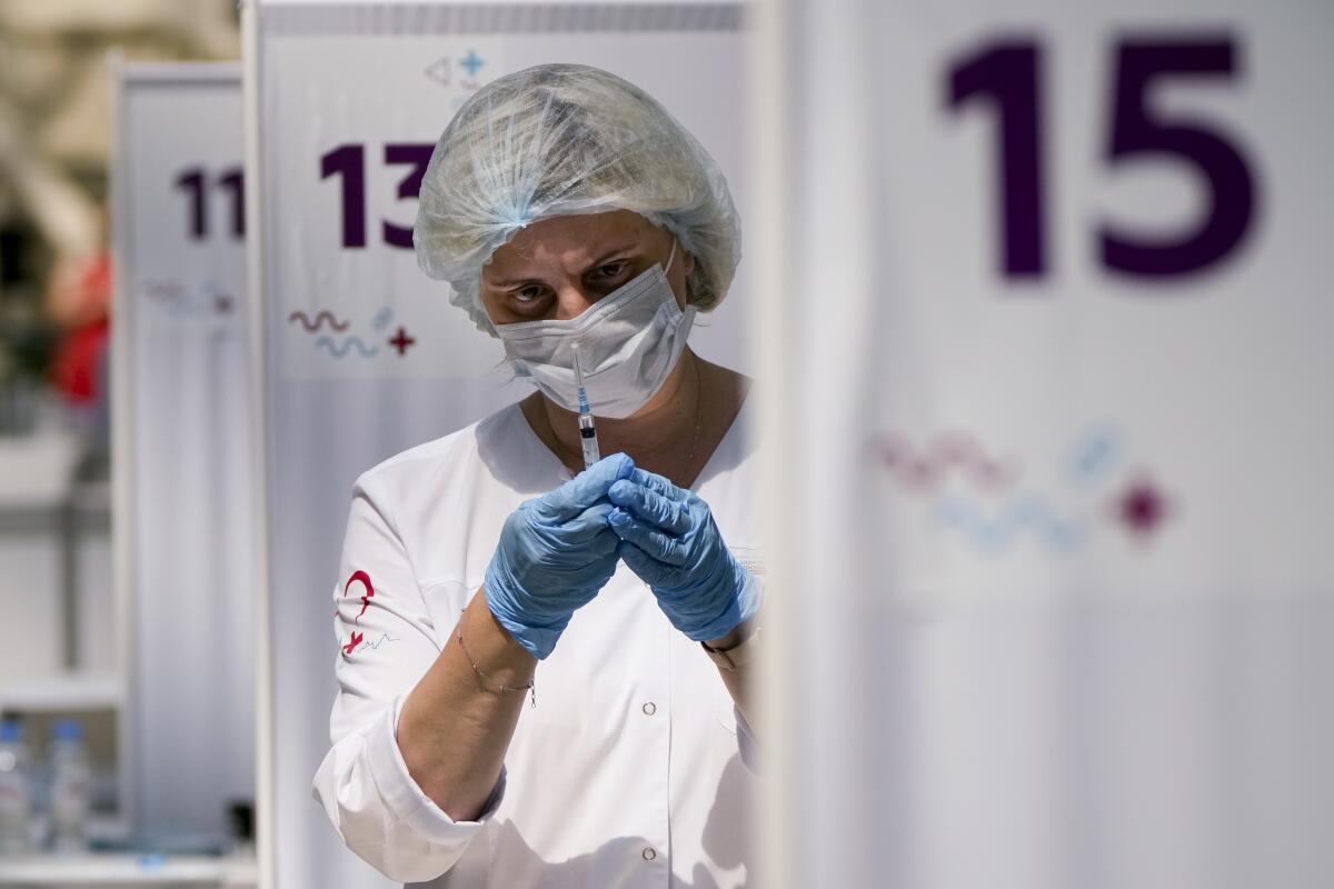 A medical worker holds a syringe containing Russia's Sputnik V COVID-19 vaccine