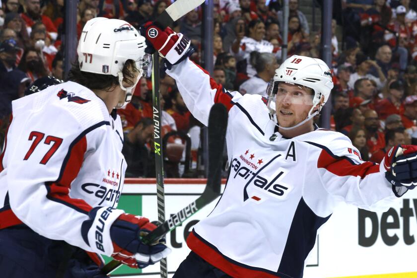 Washington Capitals center Nicklas Backstrom (19) and right wing T.J. Oshie (77) celebrate the go-ahead goal by Oshie during the third period of Game 1 of the team's NHL hockey first-round playoff series against the Florida Panthers on Tuesday, May 3, 2022, in Sunrise, Fla. (AP Photo/Reinhold Matay)