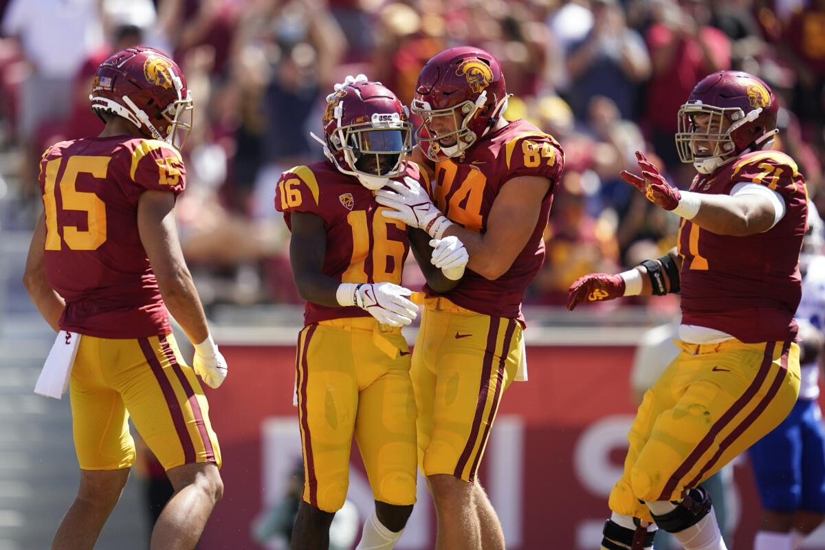 USC receiver Tahj Washington celebrates with tight end Erik Krommenhoek after catching a touchdown pass 