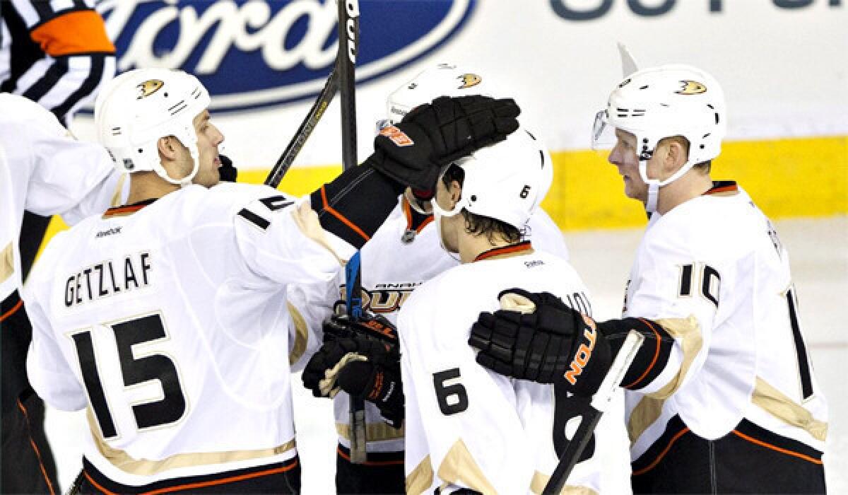 Ryan Getzlaf, Ben Lovejoy and Corey Perry celebrate a goal on the Oilers during the third period of the Ducks' 3-1 victory over Edmonton on Sunday.