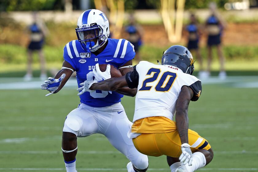 Duke's Brittain Brown (8) pulls away from North Carolina A&T's Najee Reams (20) during the first half of an NCAA college football game in Durham, N.C., Saturday, Sept. 7, 2019. (AP Photo/Karl B DeBlaker)