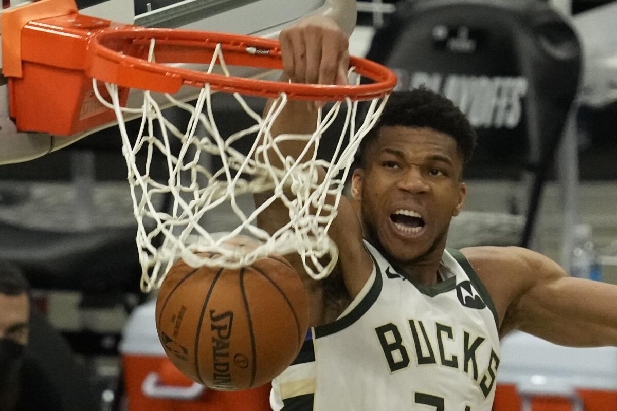 Milwaukee Bucks' Giannis Antetokounmpo dunks during the second half of Game 4 of the NBA Eastern Conference basketball semifinals game against the Brooklyn Nets Sunday, June 13, 2021, in Milwaukee. (AP Photo/Morry Gash)