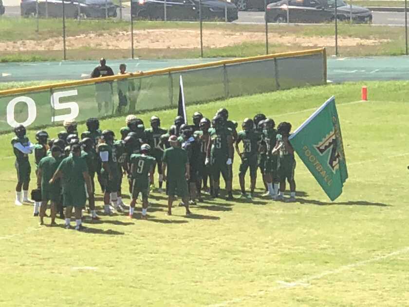 Narbonne football players preparing to enter the field during the 2018 season. More than 20 players have left school since the season ended after the team was banned from the City Section playoffs for 2019 and 2020.