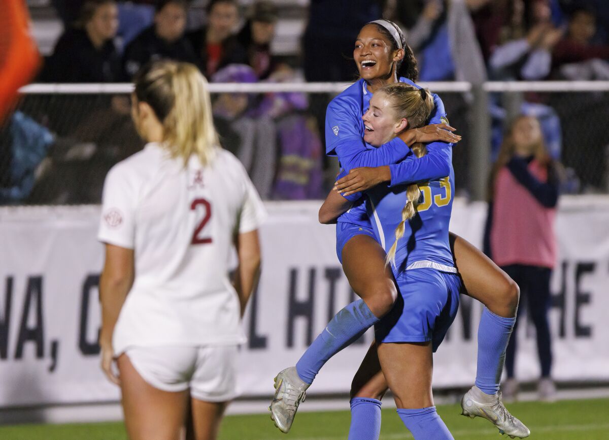 UCLA's Reilyn Turner celebrates with Ally Cook after scoring a goal during the first half.