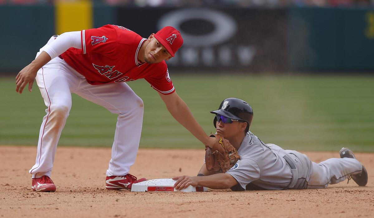 Seattle Mariners' Norichika Aoki, right, steals second as Angels shortstop Andrelton Simmons applies a late tag during the ninth inning on Sunday.
