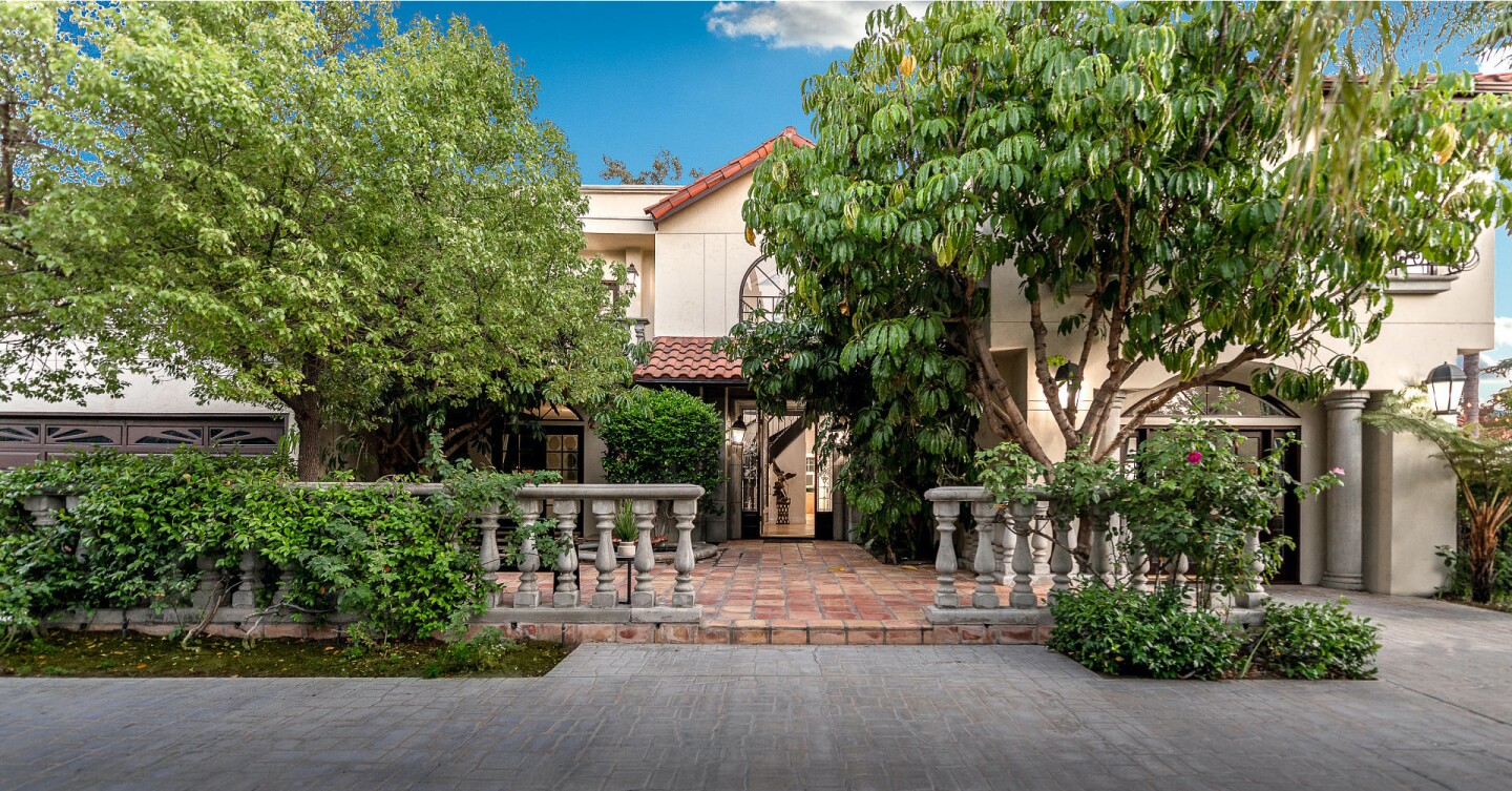The entertainer's retreat includes a resort-style backyard with a pool, spa, gazebo and cabana with a bar.