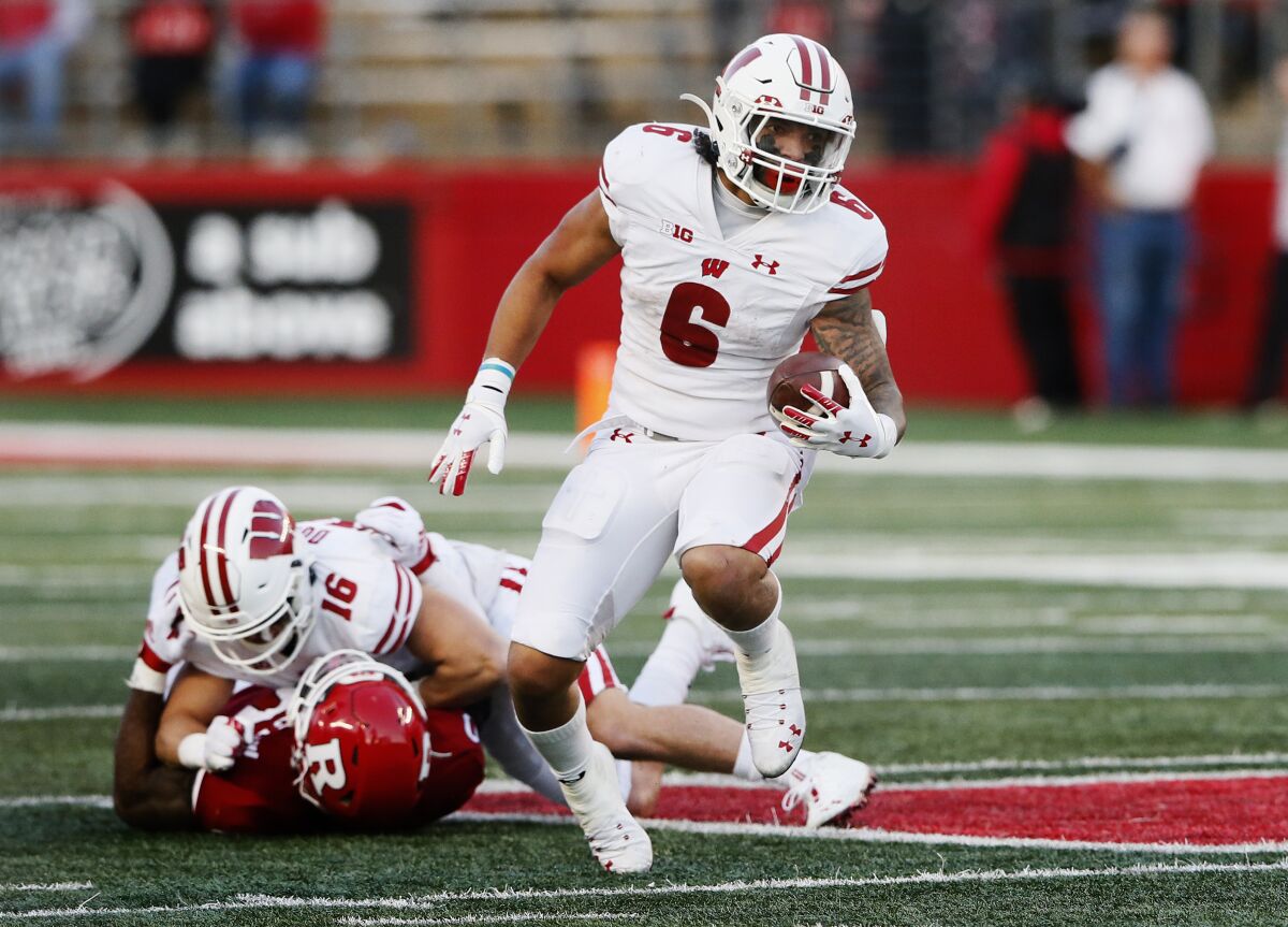 Wisconsin running back Chez Mellusi (6 )runs against Rutgers during the second half of an NCAA college football game, Saturday, Nov. 6, 2021, in Piscataway, N.J. (AP Photo/Noah K. Murray)